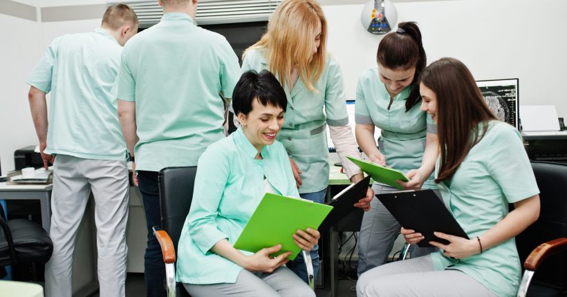 Medical theme.Observation room with a computer tomograph. The group of female doctors with clipboards meeting in the mri office at diagnostic center in hospital.